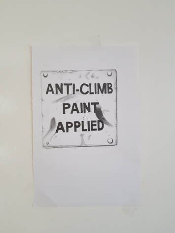 A4 sheet of white paper cellotaped to a white painted surface, on the paper an accurate drawing of a square sign with a screw hole at each corner, dirt and smudges across its surface, and in black capitalised lettering 