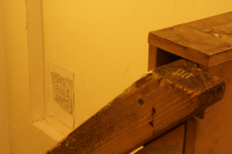 Drawing of a note which reads "Long Fold 1 (spare)", the drawing is stuck on a wall in a stairway