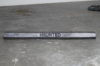 Black car stop with the word "Haunted" enscribed 